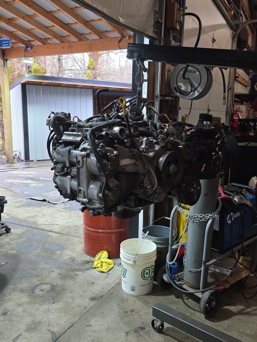 An engine pulled and hanging on the hoist