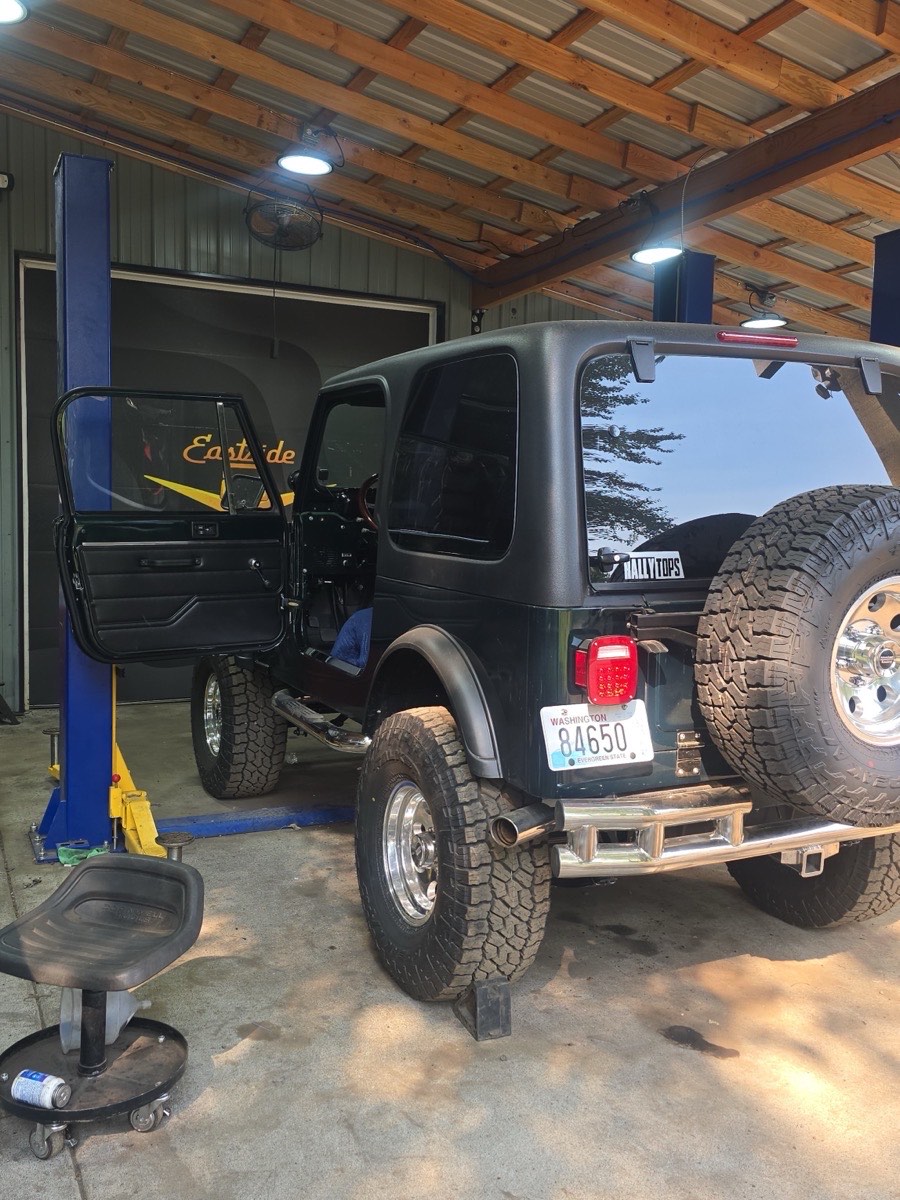 A Jeep CJ up on the lift in the Eastside Speedshop bay